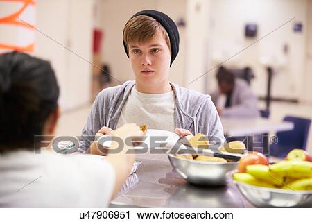 Stock Image - Kitchen Serving Food In Homeless Shelter. Fotosearch
