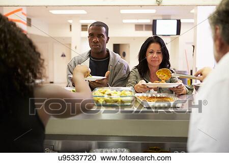 Stock Image - Kitchen Serving Food In Homeless Shelter. Fotosearch