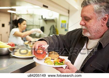 Stock Photo - Kitchen Serving Food In Homeless Shelter. Fotosearch