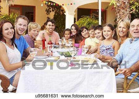Large Family Group Enjoying Meal On Terrace Together View Large Photo Image Stock Image - Large Family Group Enjoying Meal On Terrace Together. Fotosearch