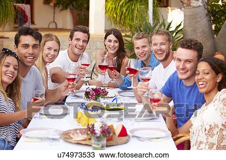 Large Group Of Young Friends Enjoying Outdoor Meal Together View Large Photo Image Stock Image - Large Group Of Young Friends Enjoying Outdoor Meal Together. Fotosearch