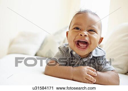 Laughing Baby Boy Lying On Tummy At Home View Large Photo Image Stock Image - Laughing Baby Boy Lying On Tummy At Home. Fotosearch