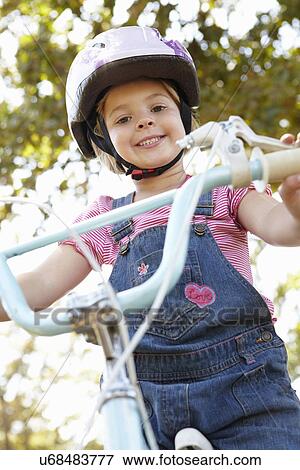 Little girl on bike View Large Photo Image Stock Photo - Little girl on bike. Fotosearch
