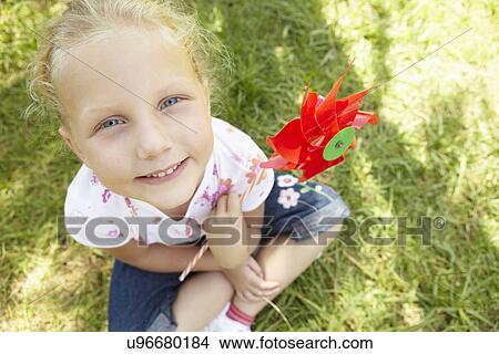 Little girl outdoors with windmill View Large Photo Image Picture - Little girl outdoors with windmill. Fotosearch