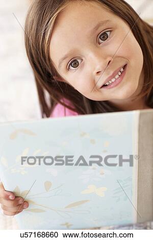 Stock Image - Little girl with book. Fotosearch