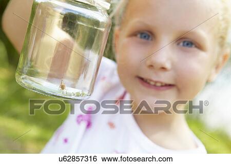 Little girl with cricket in a jar View Large Photo Image Stock Photograph - Little girl with cricket in a jar. Fotosearch
