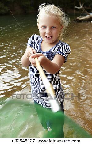 Stock Photo - Little girl with fishing net. Fotosearch