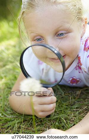 Little girl with magnifying glass View Large Photo Image Stock Photo - Little girl with magnifying glass. Fotosearch