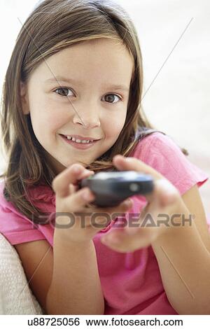 Stock Photograph - Little girl with remote control. Fotosearch