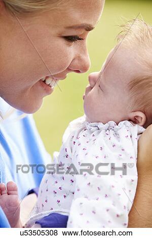 Loving Mother Holding Baby Daughter In Garden View Large Photo Image Stock Photo - Loving Mother Holding Baby Daughter In Garden. Fotosearch