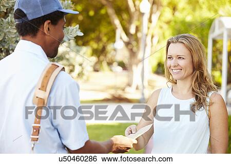 Stock Photograph - Mailman Delivering Letters To Woman. Fotosearch