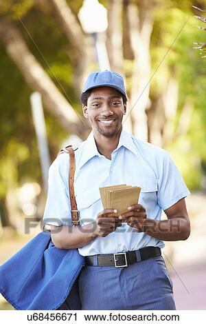 Mailman Walking Along Street Delivering Letters View Large Photo Image Stock Image - Mailman Walking Along Street Delivering Letters . Fotosearch