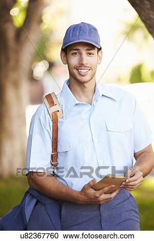 Mailman Walking Along Street Delivering Letters View Large Photo Image Stock Image - Mailman Walking Along Street Delivering Letters . Fotosearch