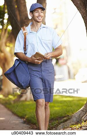 Mailman Walking Along Street Delivering Letters View Large Photo Image Stock Image - Mailman Walking Along Street Delivering Letters . Fotosearch
