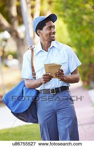 Stock Photo - Mailman Walking Along Street Delivering Letters . Fotosearch