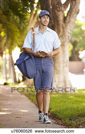 Mailman Walking Along Street Delivering Letters View Large Photo Image Stock Photograph - Mailman Walking Along Street Delivering Letters . Fotosearch