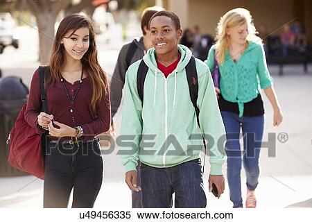 Male And Female Students Walking To High School View Large Photo Image Stock Photography - Male And Female Students Walking To High School. Fotosearch