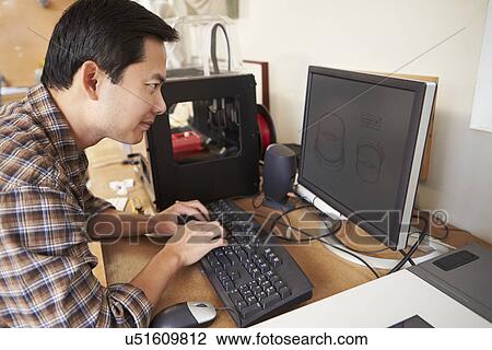 Stock Image - Male Architect Using 3D Printer In Office. Fotosearch