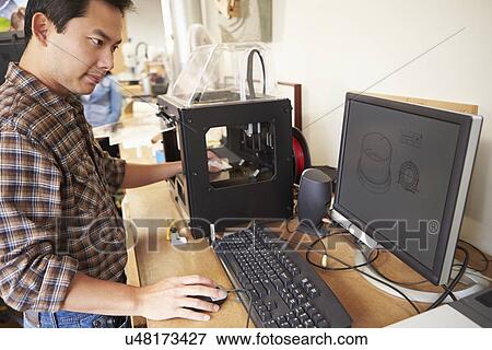 Stock Photo - Male Architect Using 3D Printer In Office. Fotosearch