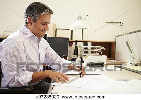Male Architect Working At Desk In Office View Large Photo Image Stock Image - Male Architect Working At Desk In Office. Fotosearch