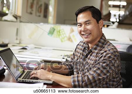 Male Architect Working At Desk On Laptop View Large Photo Image Stock Image - Male Architect Working At Desk On Laptop. Fotosearch