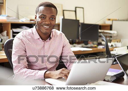 Stock Photo - Male Architect Working At Desk On Laptop. Fotosearch