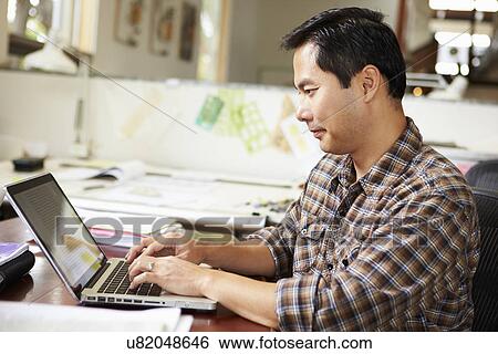 Male Architect Working At Desk On Laptop View Large Photo Image Stock Photograph - Male Architect Working At Desk On Laptop. Fotosearch