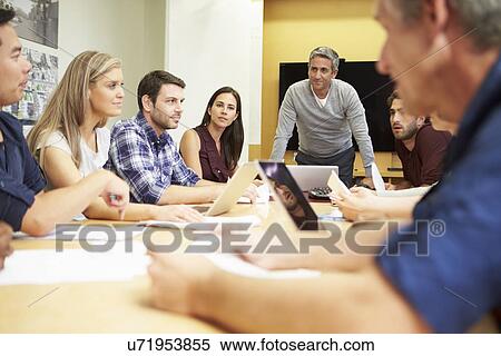 Male Boss Addressing Meeting Around Boardroom Table View Large Photo Image Stock Photography - Male Boss Addressing Meeting Around Boardroom Table. Fotosearch