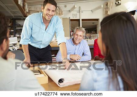 Picture - Male Boss Leading Meeting Of Architects Sitting At Table. Fotosearch