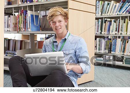 Male College Student Studying In Library With Laptop View Large Photo Image Picture - Male College Student Studying In Library With Laptop. Fotosearch