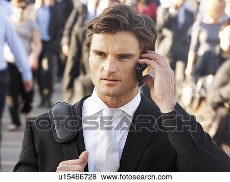 Male commuter in crowd using phone View Large Photo Image Stock Photo - Male commuter in crowd using phone. Fotosearch