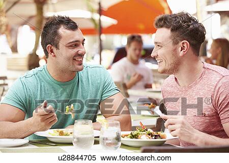 Male Couple Enjoying Lunch In Outdoor Restaurant View Large Photo Image Stock Photography - Male Couple Enjoying Lunch In Outdoor Restaurant. Fotosearch