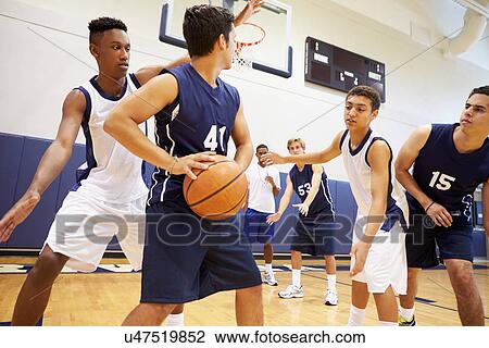 Stock Image - Male High School Basketball Team Playing Game. Fotosearch