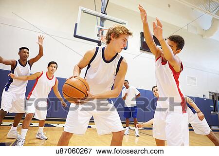 Stock Photo - Male High School Basketball Team Playing Game. Fotosearch