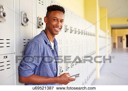 Male High School Student By Lockers Using Mobile Phone View Large Photo Image Stock Photo - Male High School Student By Lockers Using Mobile Phone. Fotosearch