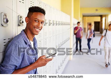 Male High School Student By Lockers Using Mobile Phone View Large Photo Image Stock Photography - Male High School Student By Lockers Using Mobile Phone. Fotosearch