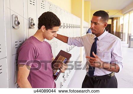 Male High School Student Talking To Teacher By Lockers View Large Photo Image Picture - Male High School Student Talking To Teacher By Lockers. Fotosearch