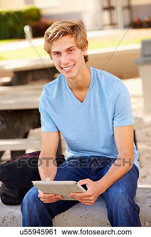 Male High School Student Using Digital Tablet Outdoors View Large Photo Image Stock Image - Male High School Student Using Digital Tablet Outdoors. Fotosearch