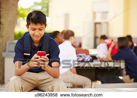 Male High School Student Using Phone On School Campus View Large Photo Image Stock Photo - Male High School Student Using Phone On School Campus . Fotosearch