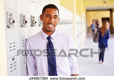 Male High School Teacher Standing By Lockers View Large Photo Image Picture - Male High School Teacher Standing By Lockers. Fotosearch