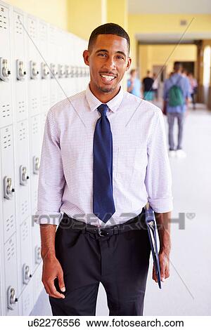 Male High School Teacher Standing By Lockers View Large Photo Image Stock Photograph - Male High School Teacher Standing By Lockers. Fotosearch