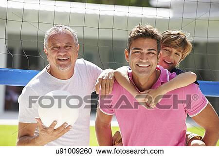 Stock Image - Male Multi Generation Family Playing Volleyball In Garden. Fotosearch