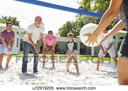 Stock Photography - Male Multi Generation Family Playing Volleyball In Garden. Fotosearch