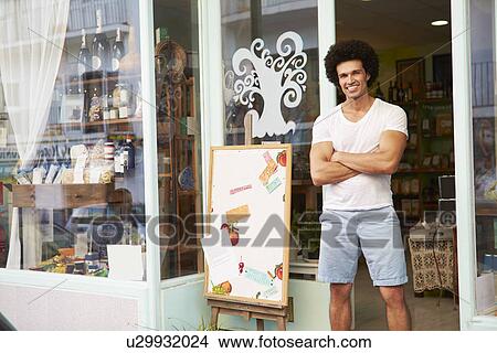 Male Owner Of Delicatessen Standing Outside Shop View Large Photo Image Picture - Male Owner Of Delicatessen Standing Outside Shop. Fotosearch