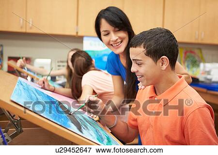 Stock Photo - Male Pupil In High School Art Class With Teacher. Fotosearch