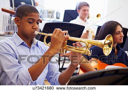 Male Pupil Playing Trumpet In High School Orchestra View Large Photo Image Stock Image - Male Pupil Playing Trumpet In High School Orchestra. Fotosearch