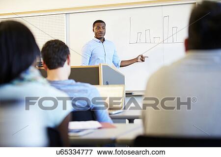 Stock Photo - Male Tutor Teaching University Students In Classroom. Fotosearch