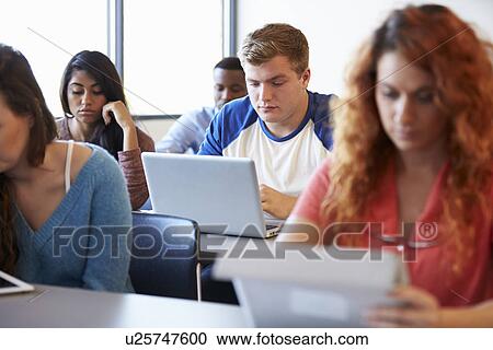 Male University Student Using Laptop In Classroom View Large Photo Image Stock Image - Male University Student Using Laptop In Classroom. Fotosearch