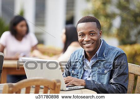 Male University Student Working On Project Outdoors View Large Photo Image Stock Photo - Male University Student Working On Project Outdoors. Fotosearch