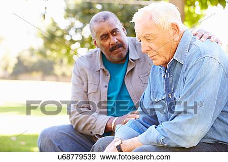Man Comforting Unhappy Senior Friend Outdoors View Large Photo Image Stock Photo - Man Comforting Unhappy Senior Friend Outdoors. Fotosearch